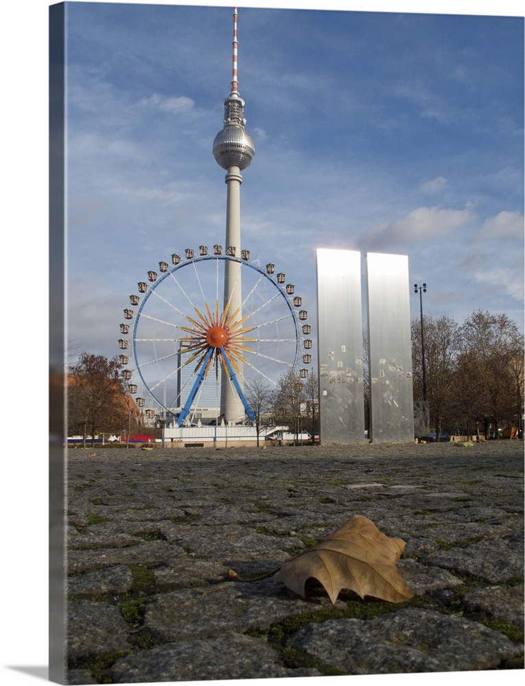 Panoramic Wheel, part of an amusement park.   Fernsehturm (TV tower) in the background.