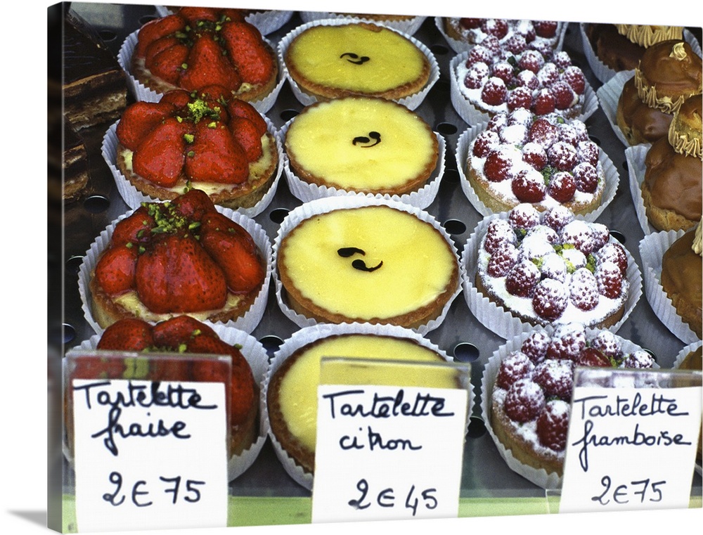 France, Paris: different pastries in a window shop.
From left to right: strawberry, lemon, raspberry.