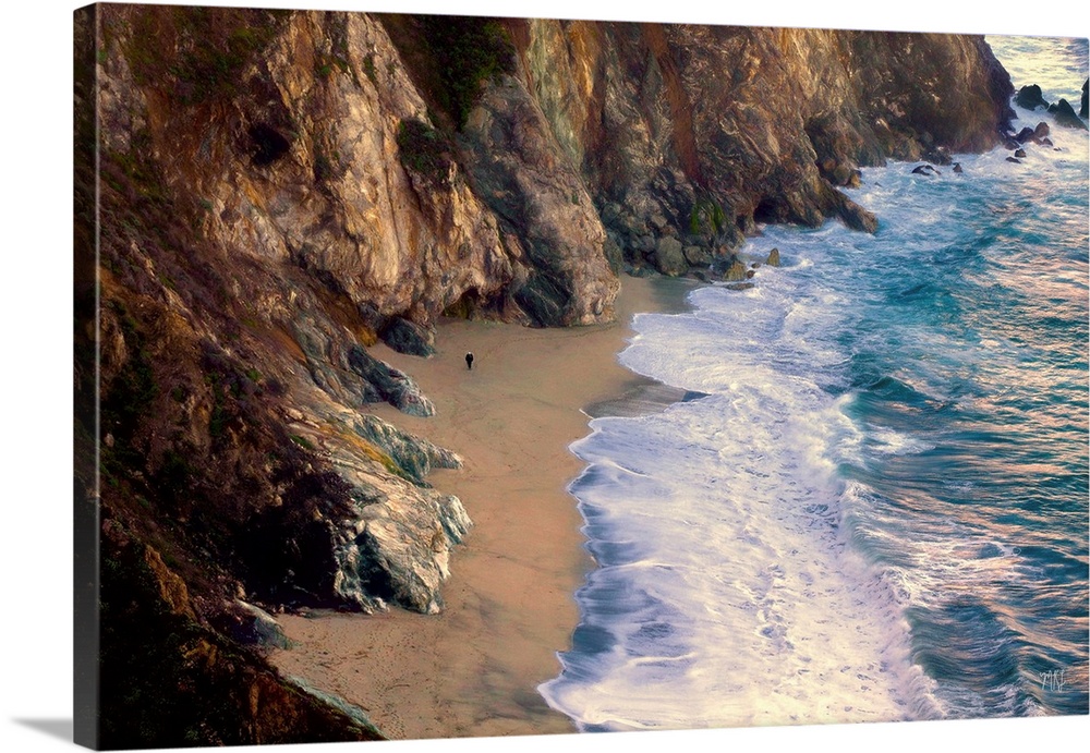 About 250 feet below the Bixby Bridge lies a beautiful beach where a local takes an afternoon stroll. His size relative to...