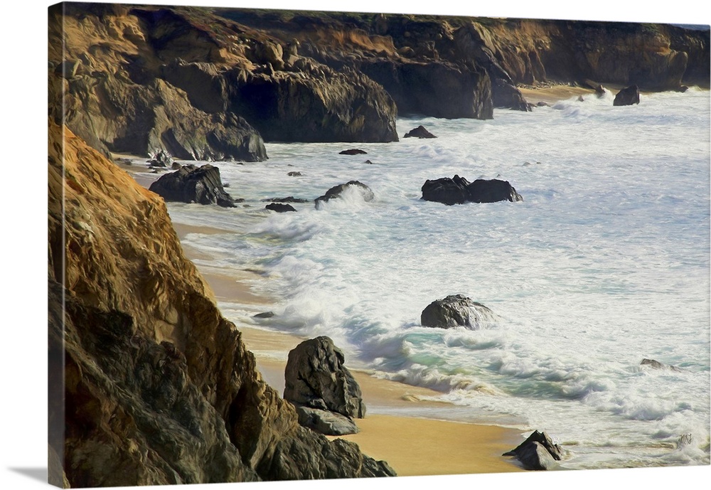 Gentle waves reach the bluffs at Garrapata Beach in Big Sur, their cool colors complementing the warm tones of the beach, ...