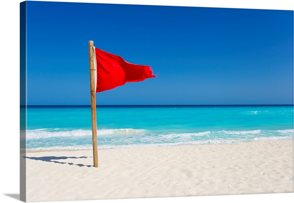 A red flag is posted as a warning of caution on the beaches of Cancun, Mexico.