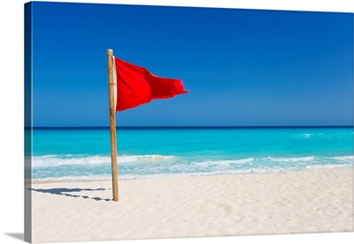 A red flag is posted as a warning of caution on the beaches of Cancun, Mexico