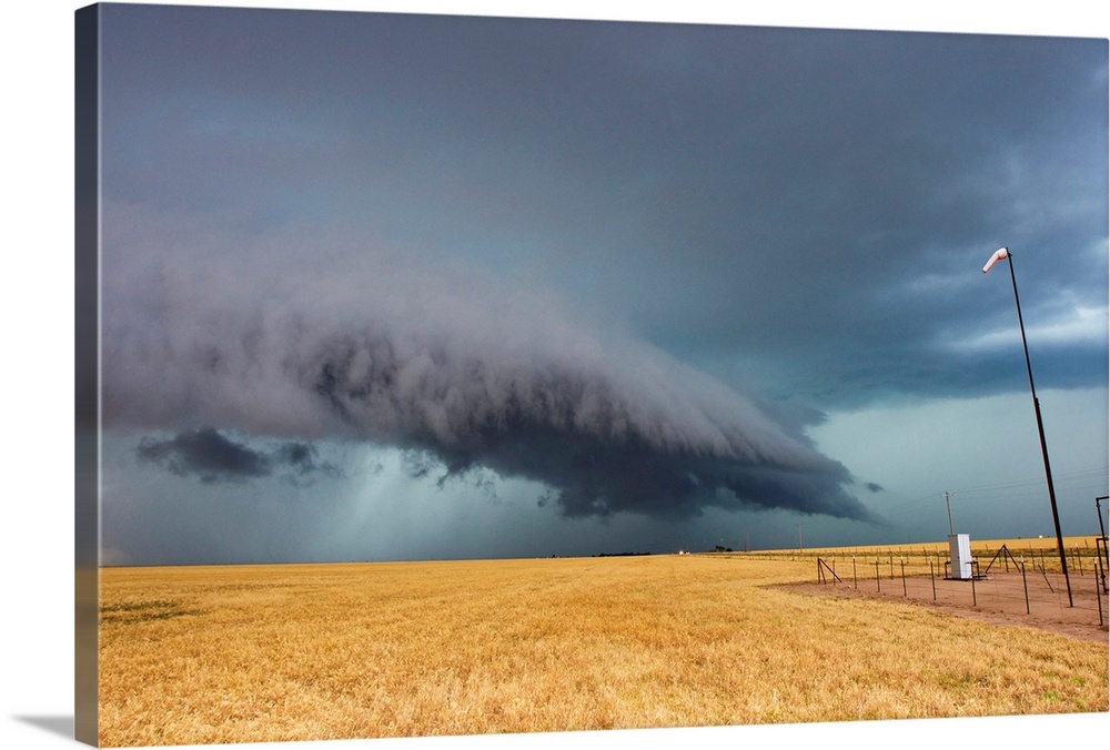 A shelf cloud from a thunderstorm provides water to crops.
