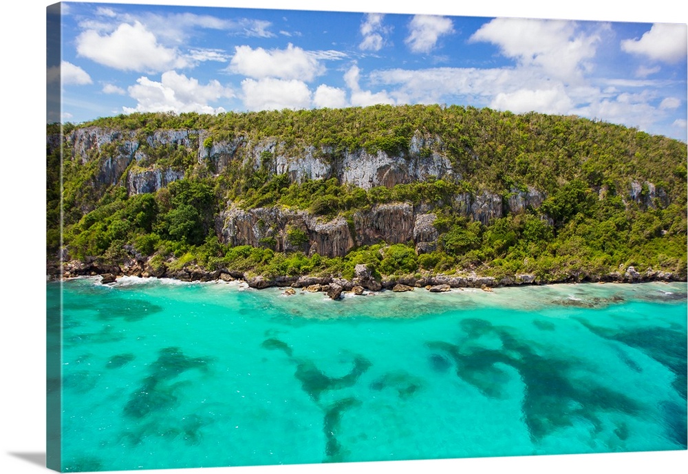 An aerial view of tall cliffs and turquoise water on the north coast of Jamaica.