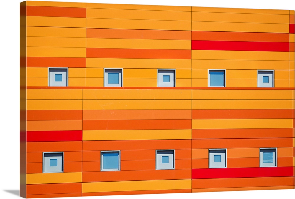 An modern building decorated with bright orange stripes.