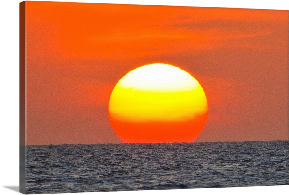 Close up of the sun setting over the Gulf of Mexico.