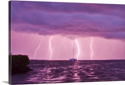 Lightning bolts striking the ocean, and almost hitting a sailboat