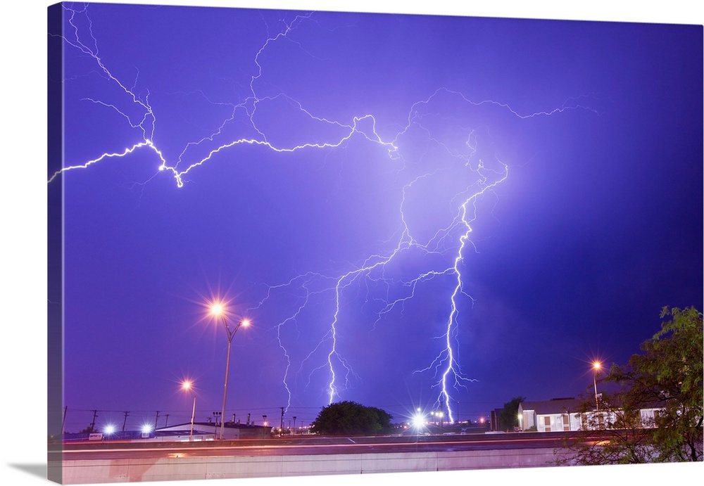 Multiple lightning bolts stike from an intense lightning thunderstorm.