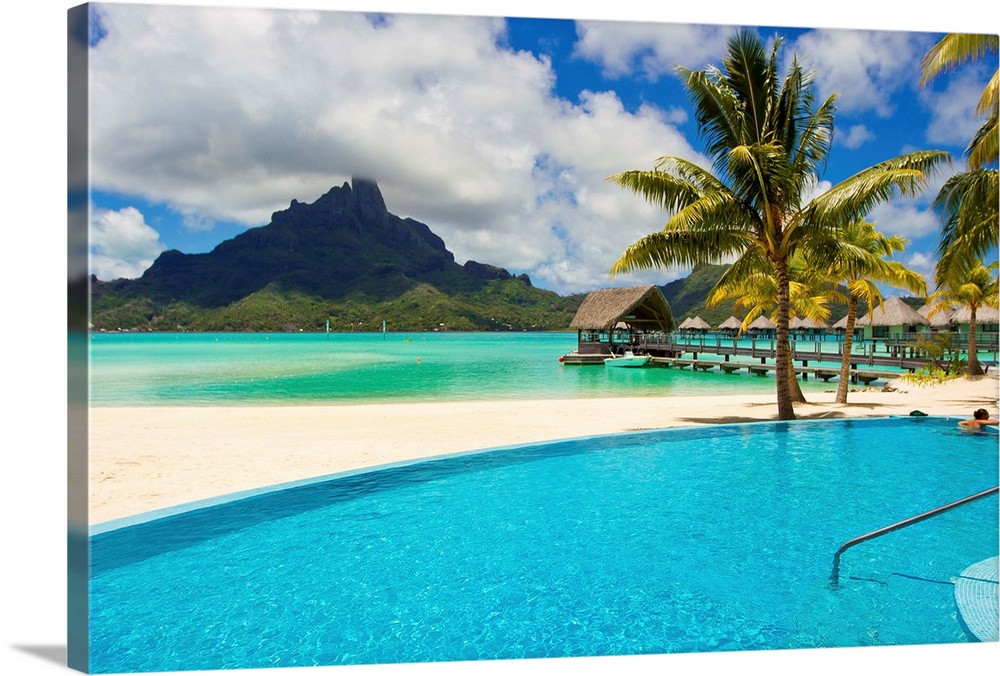 A swimming pool on the beach at the Le Meridien resort, with Mount Otemanu in the distance.