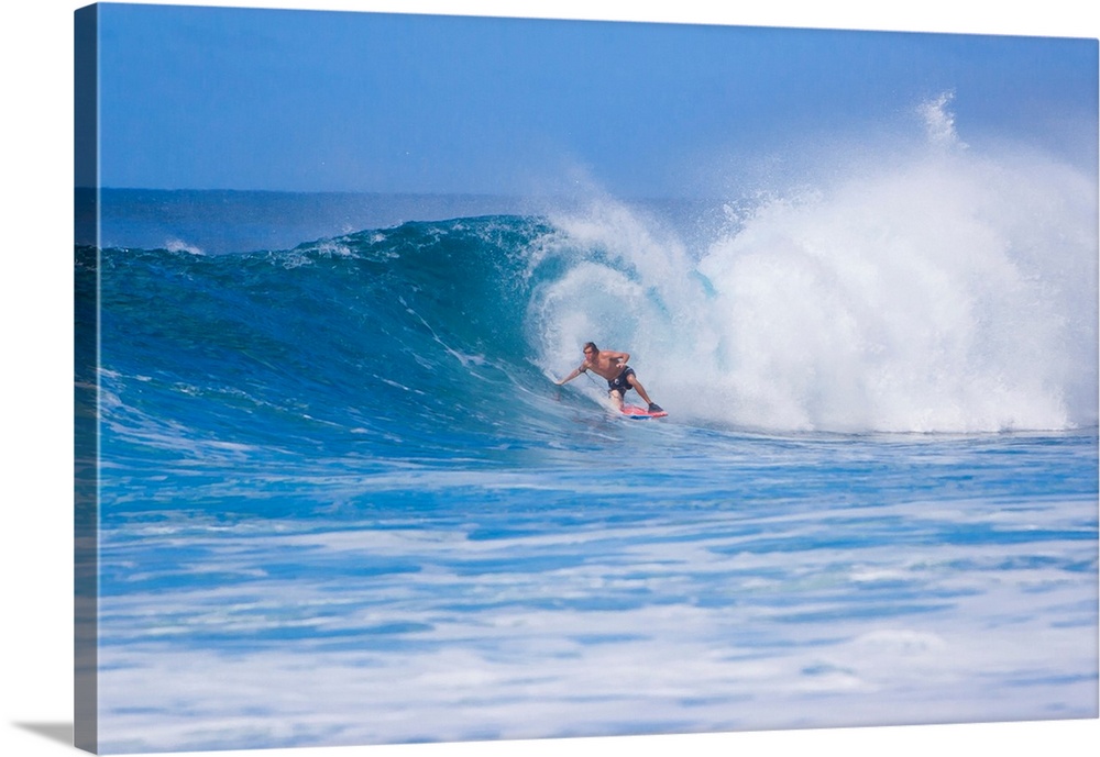 Surfer riding the famous Banzai Pipeline, on Oahu's North Shore.
