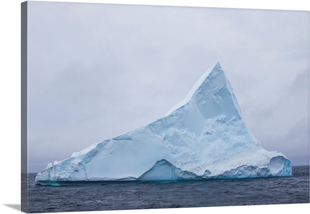 Tabular iceberg with a point in Antarctica.