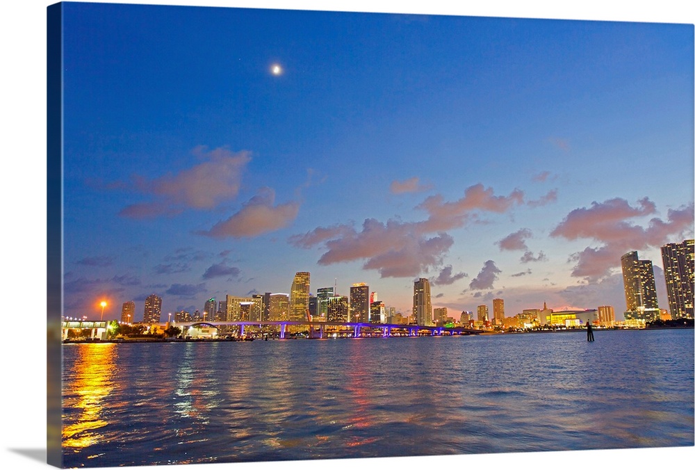 The full moon over Miami's skyline at dusk.