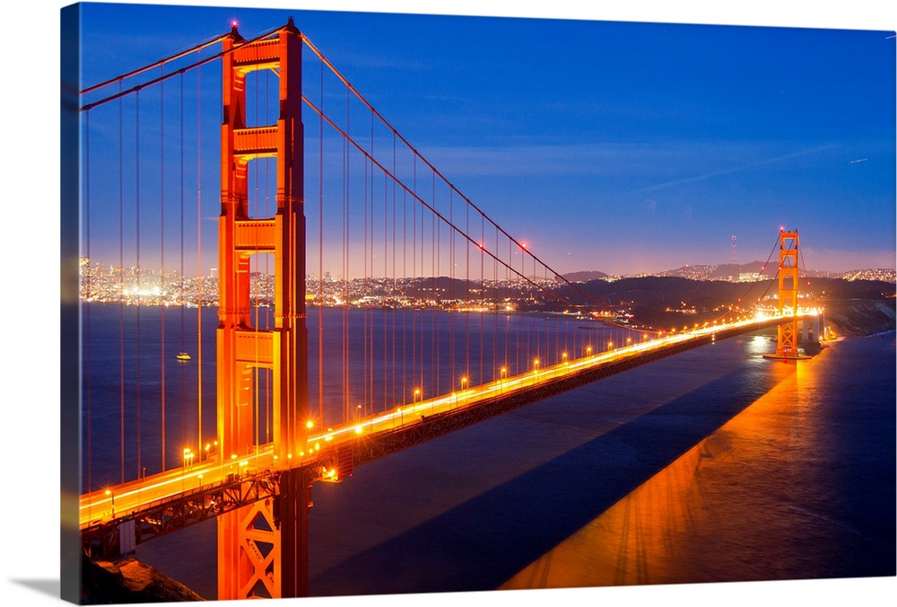 The Golden Gate Bridge illuminated at night.