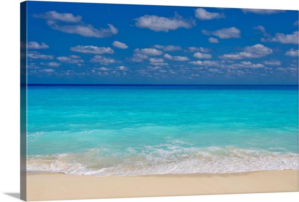Turquoise water and soft beaches create a paradise at Cancun, Mexico. The pristine waves wash over the white sands of the ...