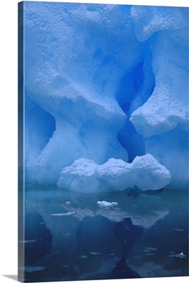 Eroded base of iceberg in snowstorm, Pleneau Island, Antarctic Peninsula, Antarctica
