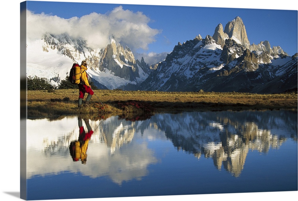 Hiker, Cerro Torre and Fitzroy reflected in small pond at dawn, Loma Plieque Tumbado, Los Glaciares National Park, Patagon...