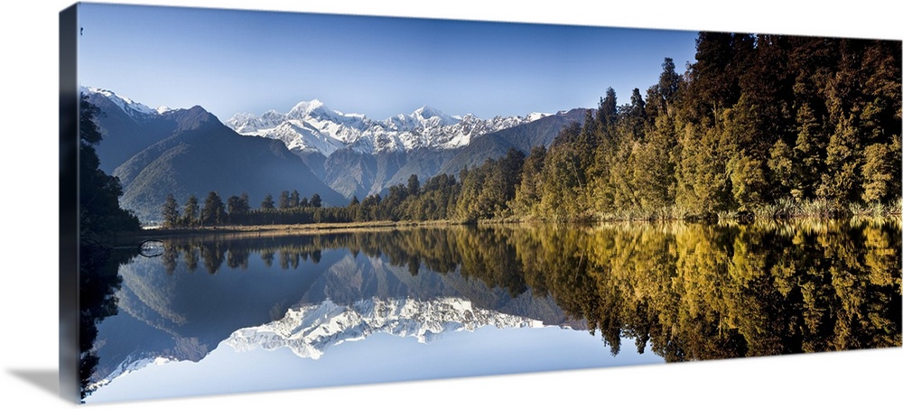 Mount Cook and Mount Tasman reflected in Lake Matheson at sunset near Fox Glacier, New Zealand
