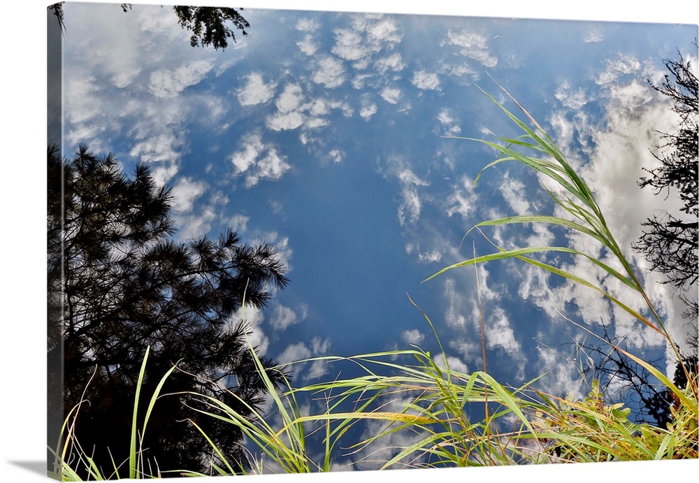 reflection of white clouds and blue ky in Mersey River, Nova Scotia, Canada