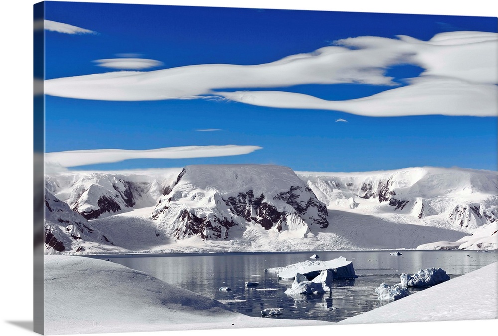 Snow-covered mountains along coast, Antarctica.