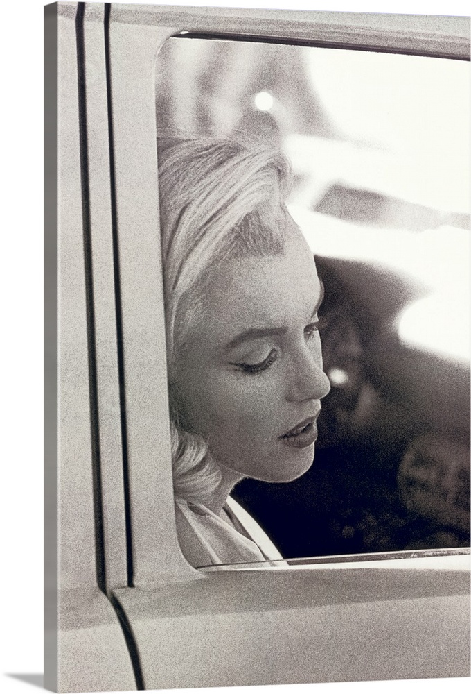 Vintage photo of the popular celebrity resting her head against the window of a car door, her eyes closed and mouth partly...