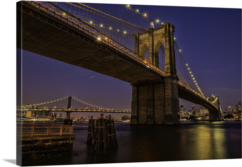 A photograph of the Brooklyn bridge at twilight.