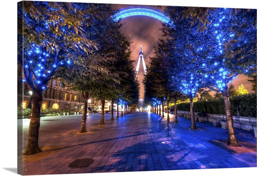 HDR photograph of a view of the London Eye through a grove of lit up trees for Christmas.