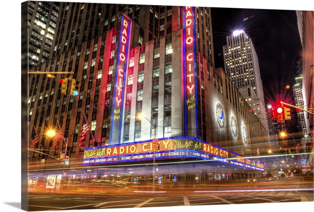 HDR photograph of the Radio City building in New York city, with light trails from speeding cars.