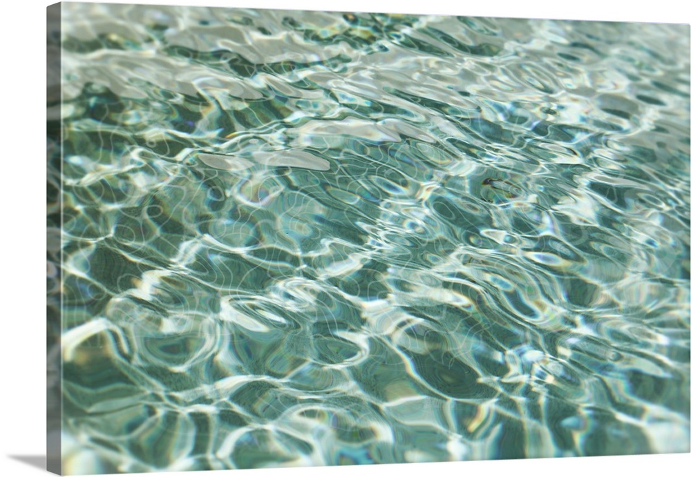Abstract image of light forming patterns on rippling water.