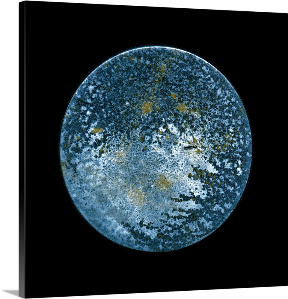 A minimalist circular surreal moon on a black background in textured blues and silvery shades.