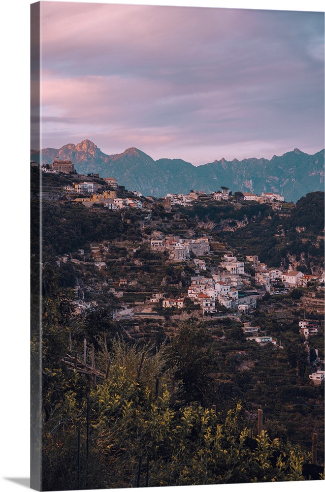 Cliffhouses and mountain backdrop during sunset in the UNESCO town of Amalfi in Amalfi Coast, Italy.