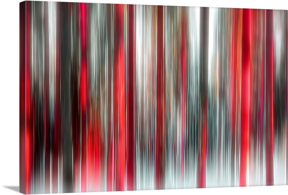 An abstract photograph of a forest in red and black in a vertical motion blur.