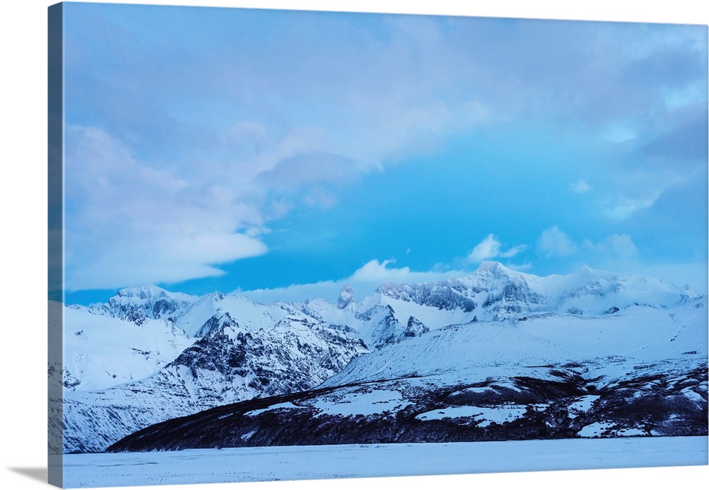 Snowy mountains landscape on blue sky background in Iceland