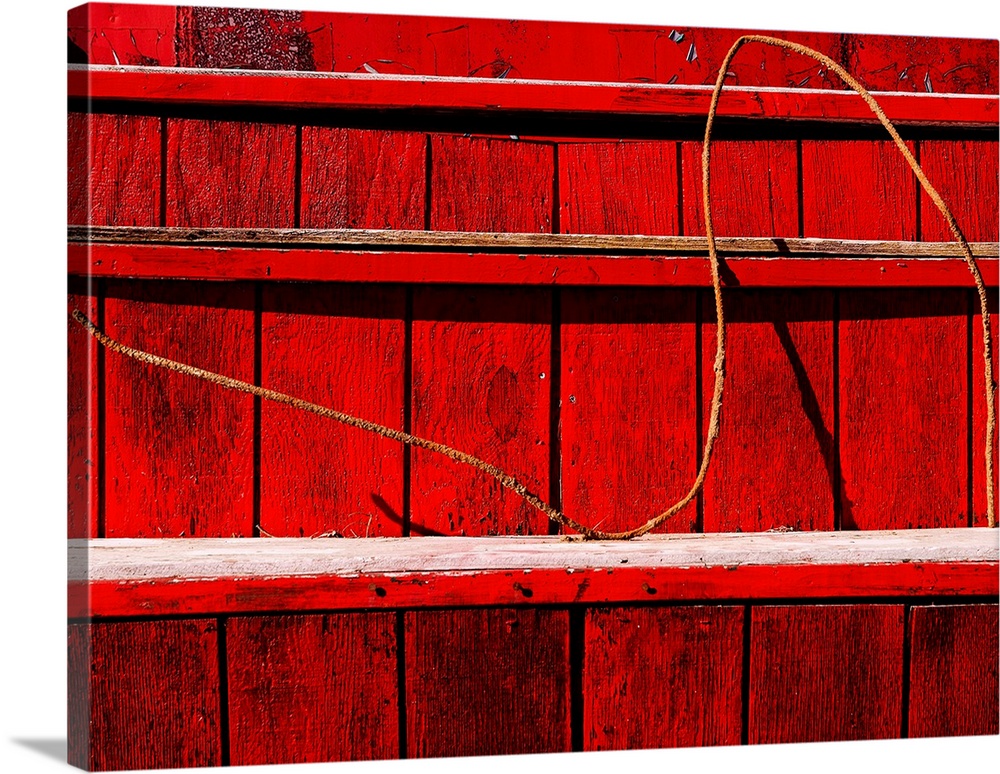 Wire on a red wooden staircase, creating an abstract image.