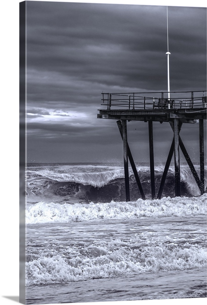 Pier over rough ocean waters during a storm in New Jersey.