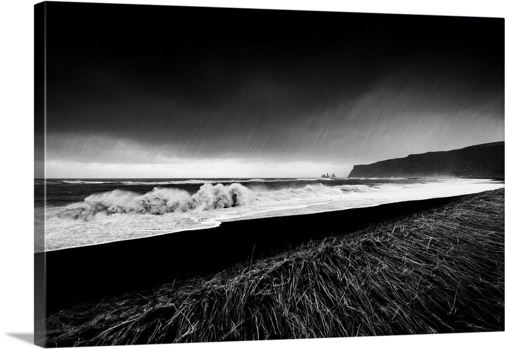 A black and white photograph of a coastal landscape.