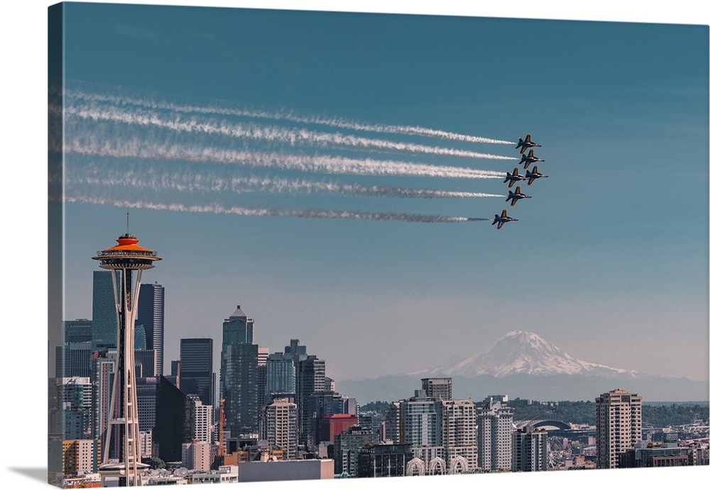 Blue Angels air show over Space Needle in Seattle with Mt Rainier in the background.