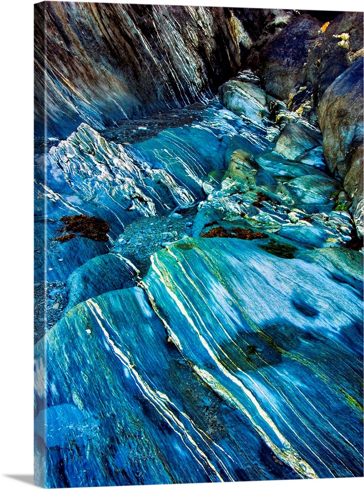 Fine art photo of a turquoise stream flowing over a rocky riverbed.