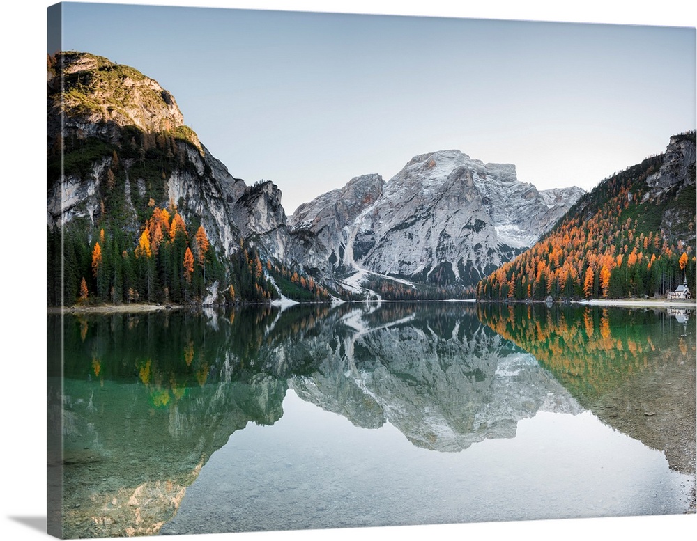 Fine art photograph of the snowy mountains in Italy reflected in Braies lake.