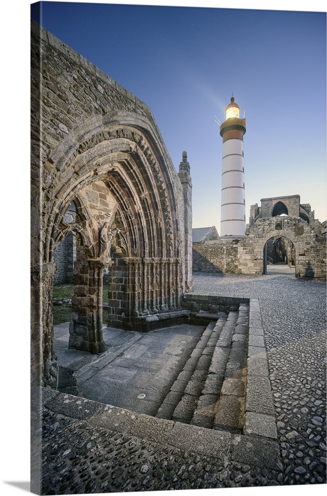 Lighthouse overlooking an ancient stone church in Bretagne.