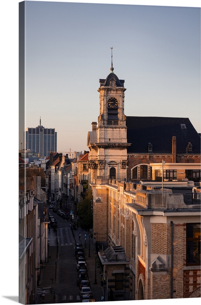 Closeup city view of both historical and modern buildings in Brussels, Belgium during sunset.