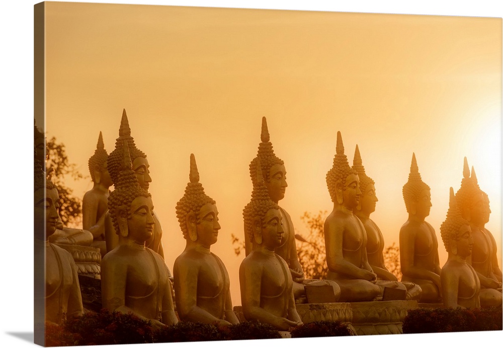 Sunset in front of rows of buddhas