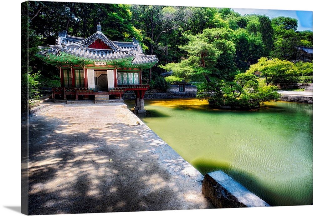 Fine art photo of a pond and small building in a garden in South Korea.