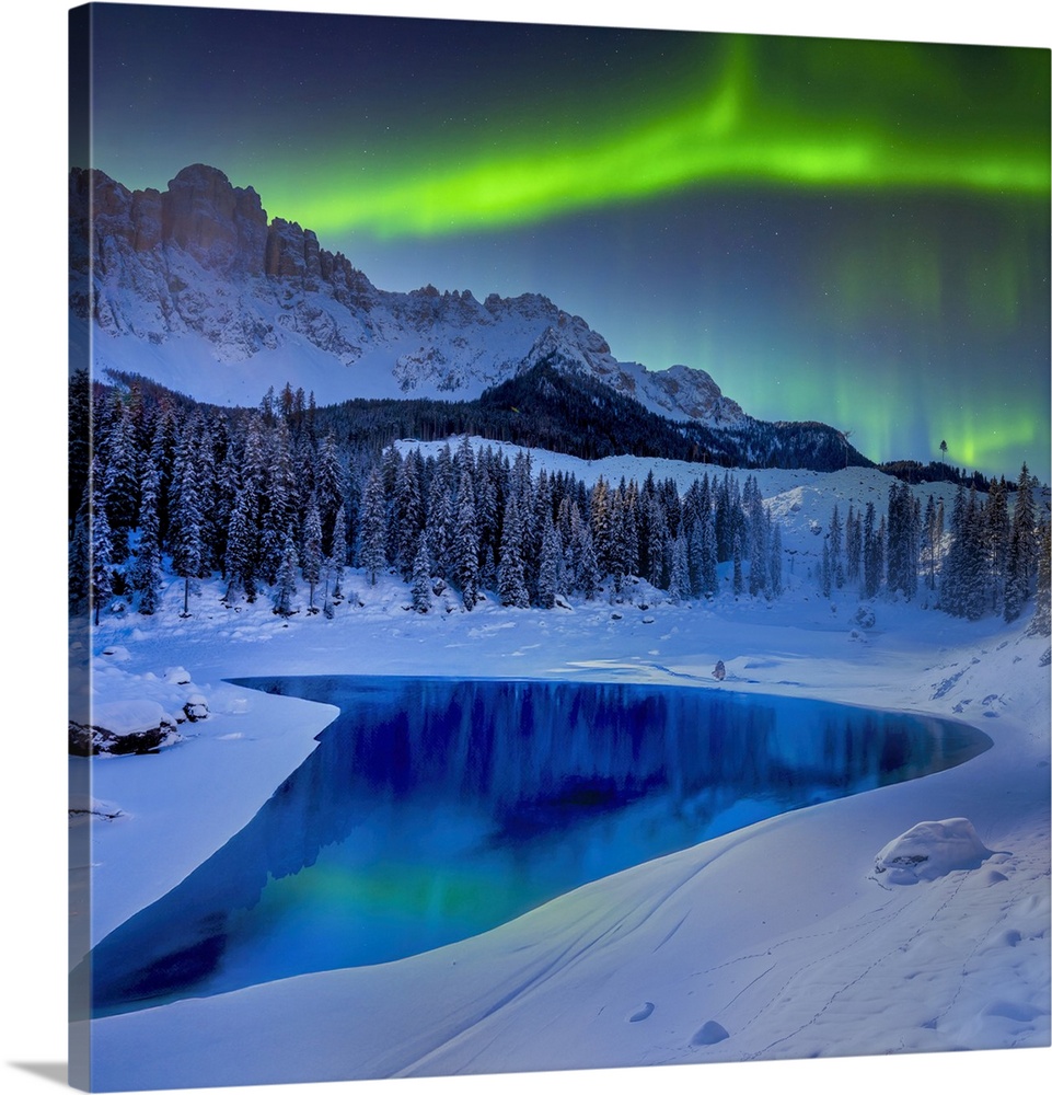 This is an image composed of a photo of a lake between mountains and snow and a photo of the Northern Lights. Together the...