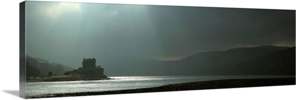 Eilean Donan Castle in Green storm light with crepuscular God's Rays casting silver light on the loch near the Isle of Sky...