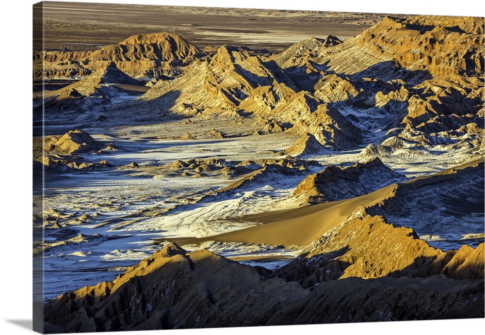 Orange light on the rocky landscape of the Andes mountains in Chile.