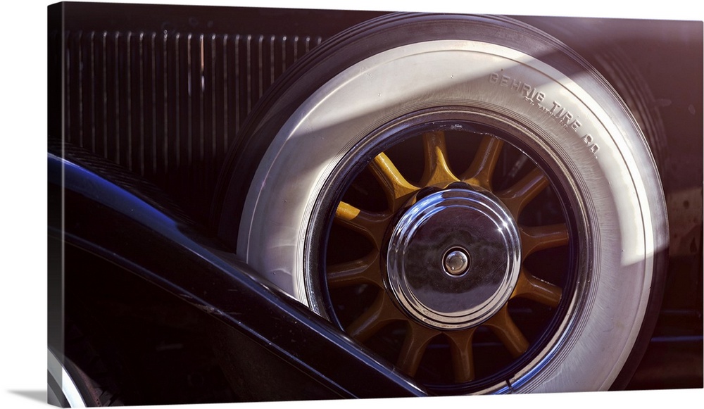 Close Up View of a Woddeen Spoked Spare Wheel with Whitewall Tires of an Antique Automobile