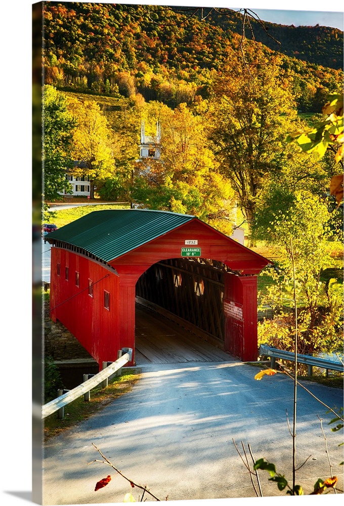 Fine art photo of a red covered bridge in Vermont in the fall.