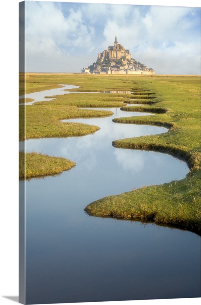Around Mont Saint Michel in France. After high tides, some nices water draws on the green lands call polders. Vertical view.