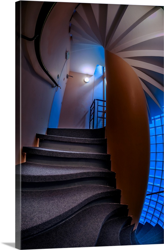 Warped, twisted steps and walls in a stairwell with blue light.