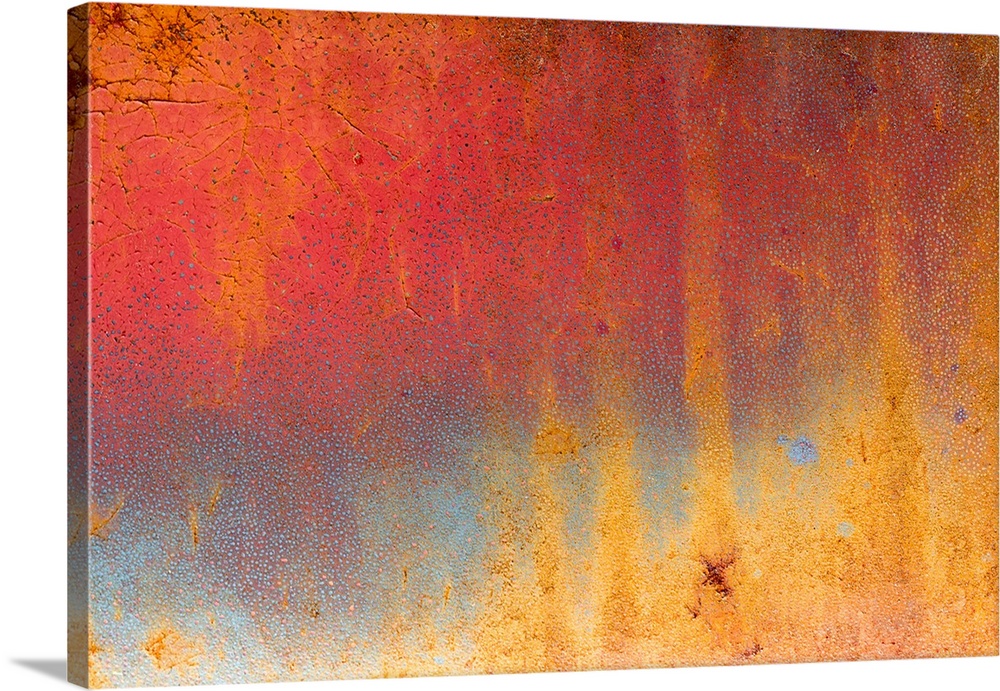 Abstract macro image of paint and rust on a vintage Dodge truck, in shades of bright red and gold.